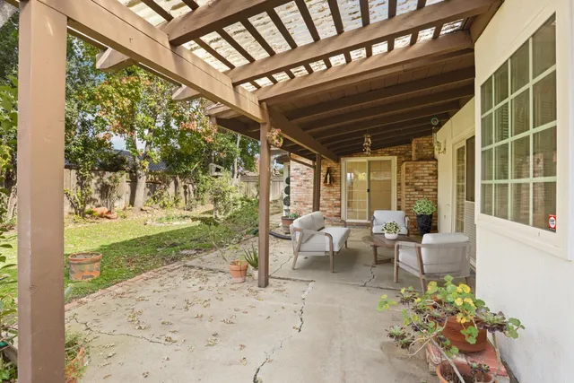 a view of an empty room with a fireplace and a window