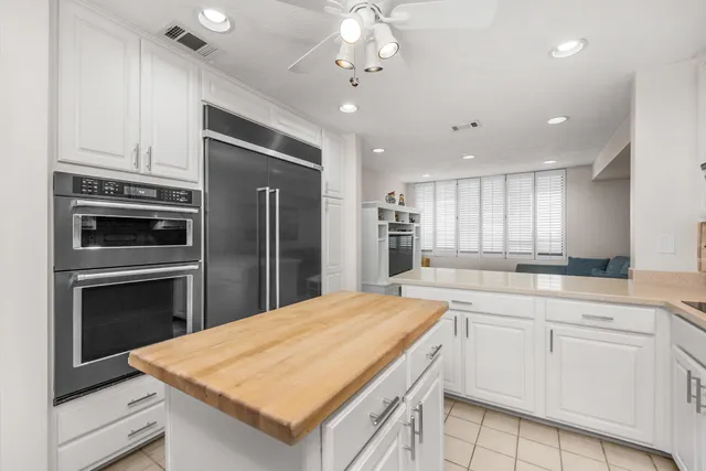 a kitchen with a sink window and cabinets