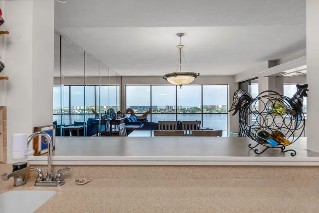 a view of a dining room with furniture large windows and wooden floor