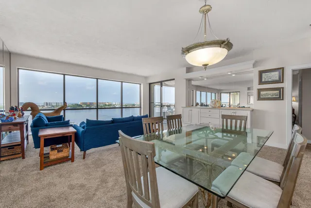 a living room with furniture and kitchen view