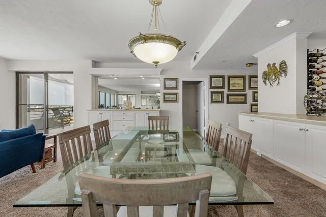 a living room with furniture and view of kitchen