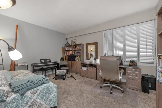 a bedroom with a large bed and a chandelier