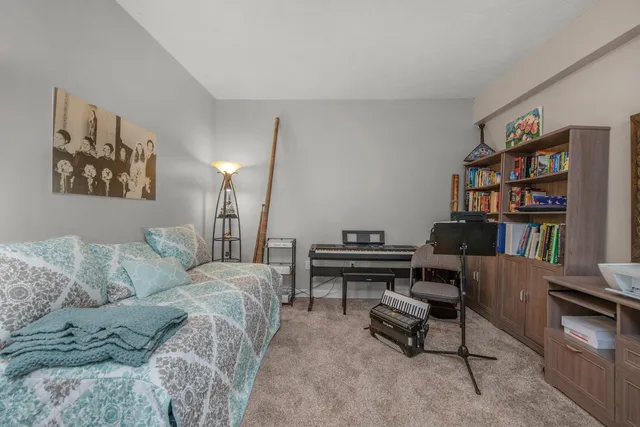 a spacious bedroom with a bed and a chandelier