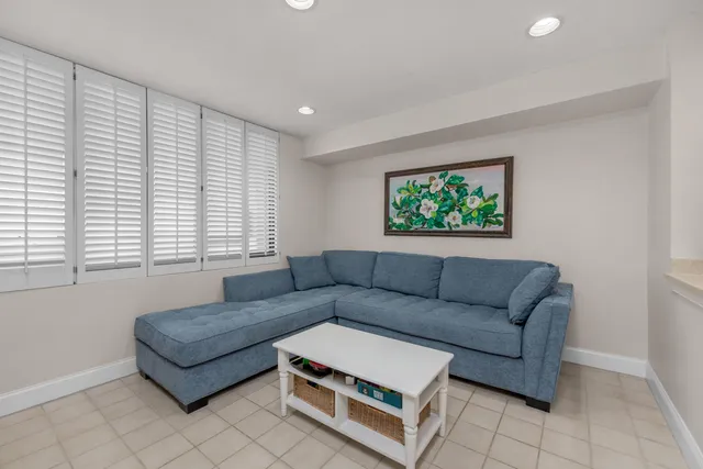 a living room with furniture and kitchen view