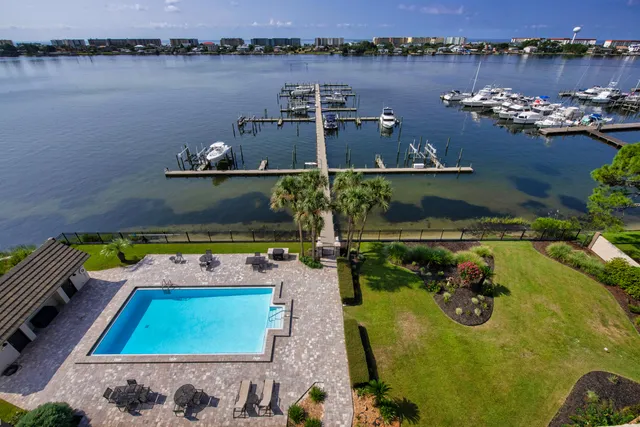 a view of a chairs and table in the patio with a barbeque