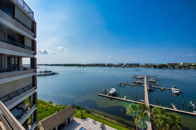 a view of a lake with boats and trees in the background