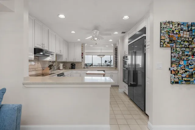 a kitchen with stainless steel appliances granite countertop a sink a stove and cabinets