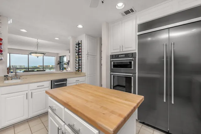 a kitchen with cabinets appliances a sink and a counter top space