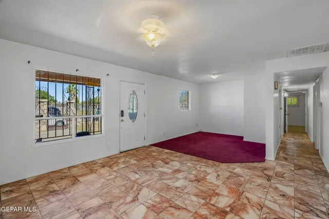 a kitchen with stainless steel appliances kitchen island granite countertop a refrigerator and cabinets