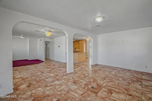 a bedroom with a bed and a view of living room