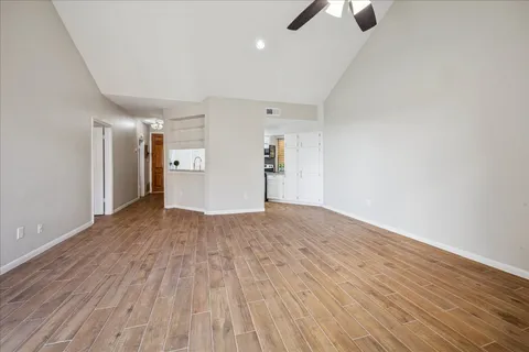 a view of empty room with wooden floor