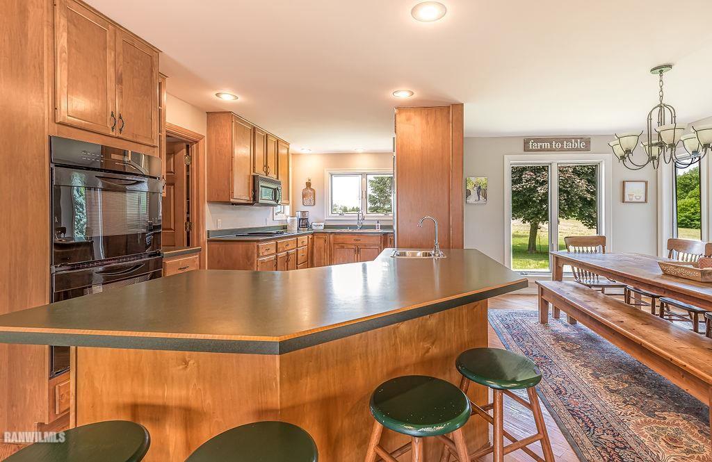 10143 South Massbach Road Elizabeth, IL 61028 - Photo 7 of 43 a view of a living room and kitchen with a large window