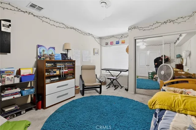 a bedroom with furniture and a flat screen tv
