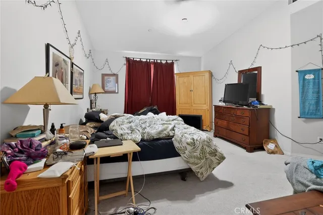 a bedroom with a bed and a chair