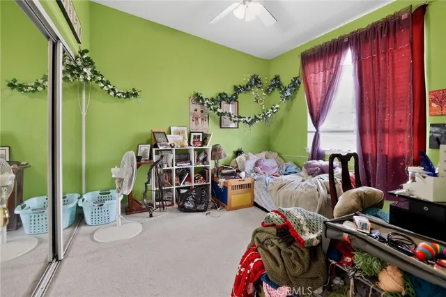 a bed room with a bed and a chair