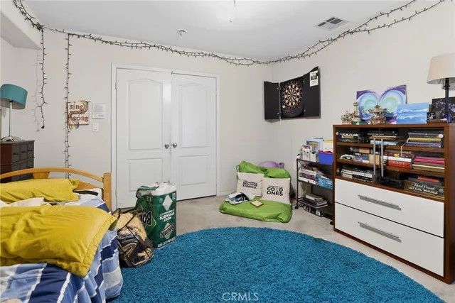 a bedroom with a bed and flat screen tv