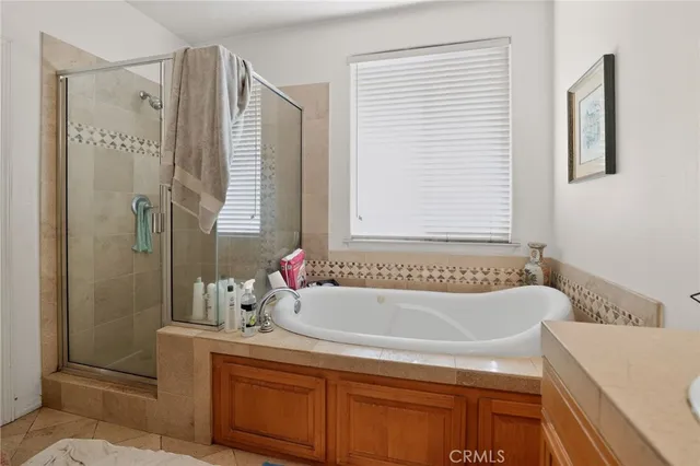 a bathroom with a tub double sink and mirror