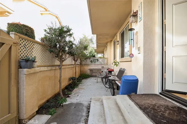 a backyard of a house with wooden fence and chairs
