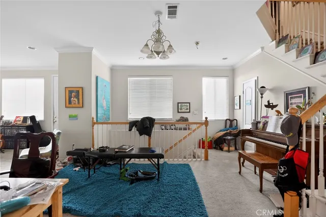 a view of a livingroom with furniture and a flat screen tv