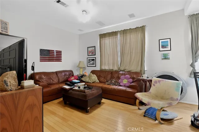 a living room with furniture a computer and a piano
