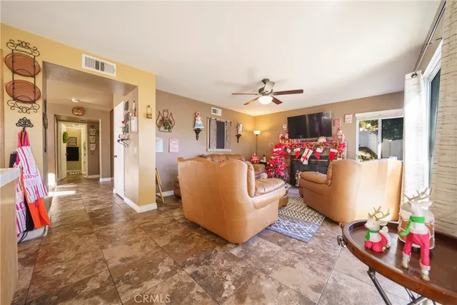 a living room with furniture and a floor to ceiling window