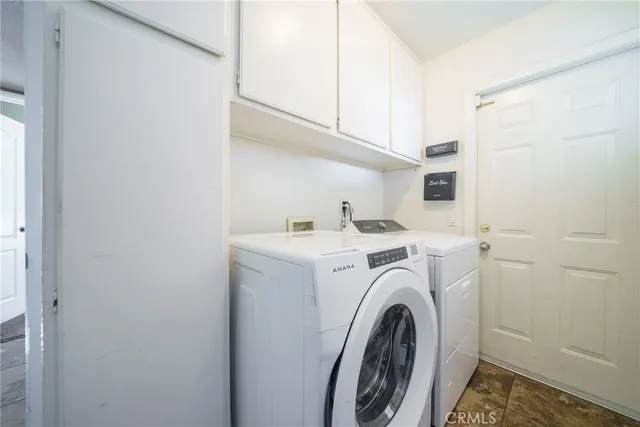 a bedroom with a bed and a flat tv screen on dresser