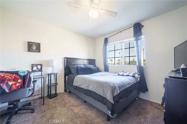 a bed room with a bed and a television