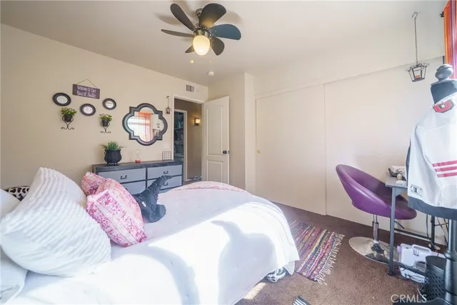 a bedroom with bed and a chandelier