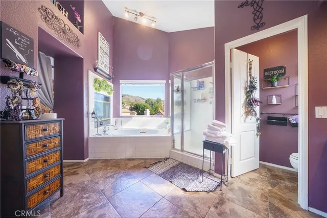 a view of a patio with a table and chairs potted plants