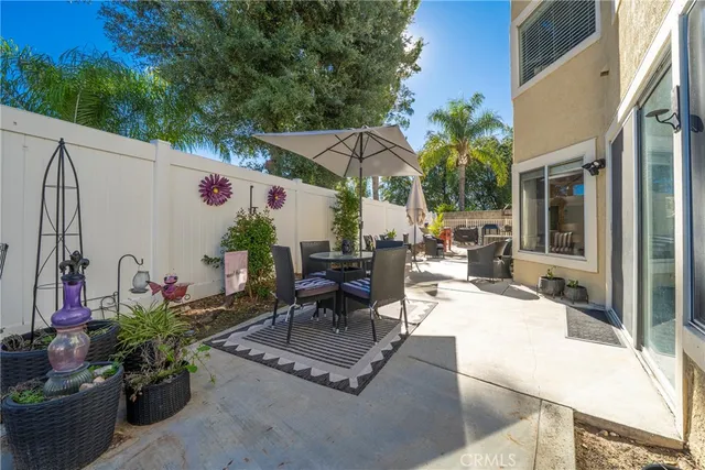 a view of backyard with outdoor seating and plants