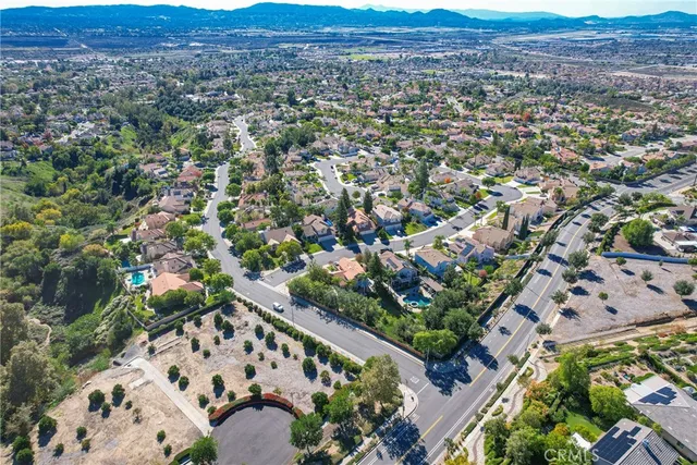 an aerial view of multiple houses with yard