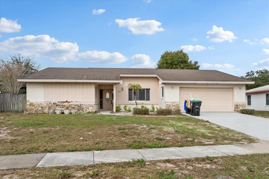 a view of a house with a yard and garage
