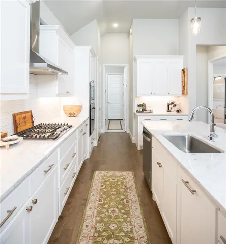 a kitchen with sink cabinets and stove