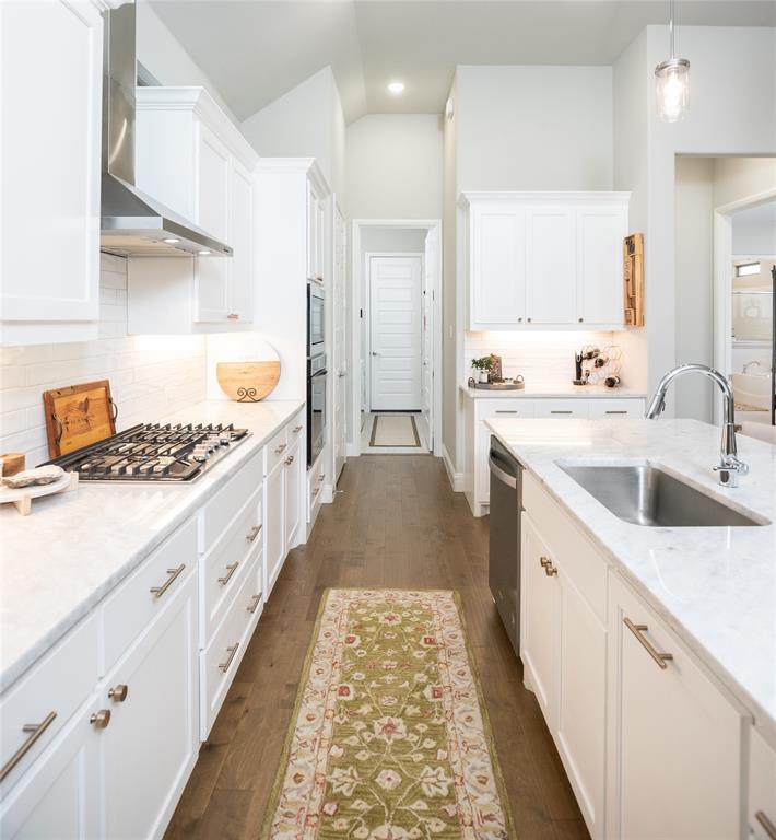 4841 Miles Way Fairview, TX 75069 - Photo 11 of 23 a kitchen with sink cabinets and stove