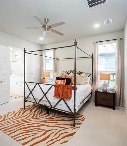 a spacious bedroom with a bed and window