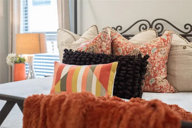 a bedroom with a bed and a painting on the wall