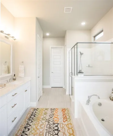 a bathroom with a tub sink and mirror