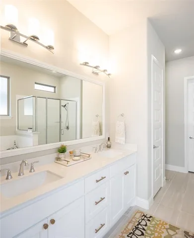 a bathroom with a sink double vanity and a mirror