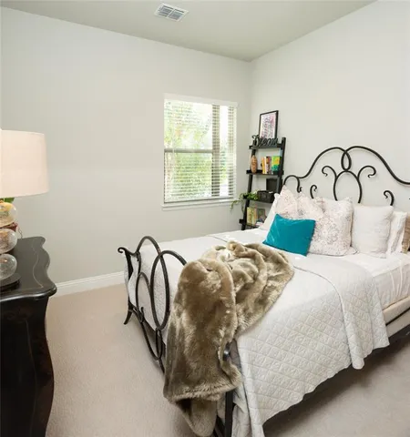 a bedroom with a bed a table with window