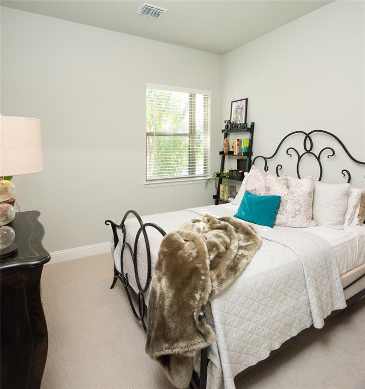 4841 Miles Way Fairview, TX 75069 - Photo 19 of 23 a bedroom with a bed a table with window