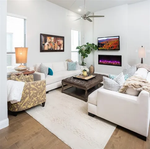 a living room with furniture and painting on the wall