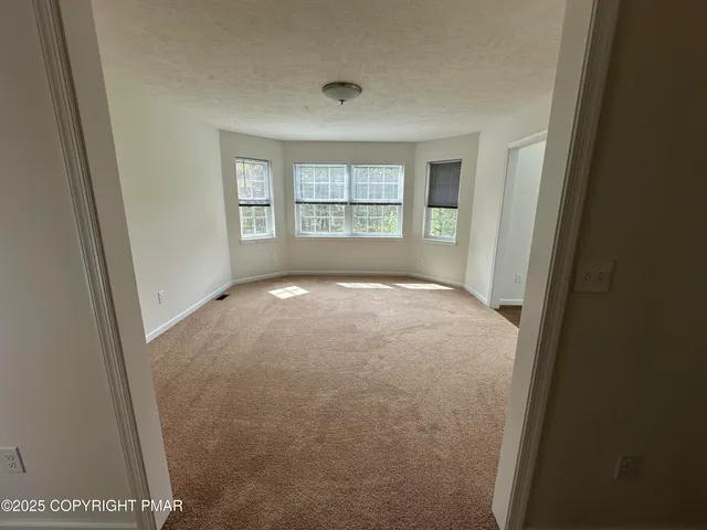 a kitchen with stainless steel appliances granite countertop a refrigerator a sink a stove and a wooden floors