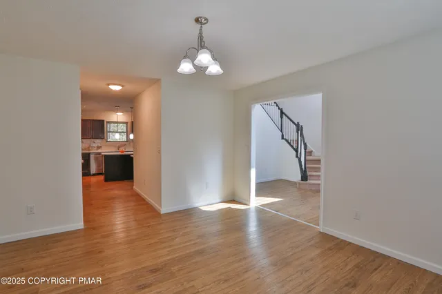 a view of kitchen with kitchen island microwave and cabinets