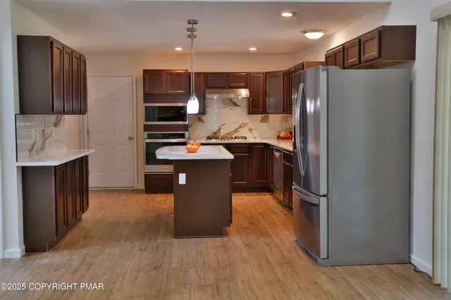 a bathroom with a double vanity sink a toilet and a window
