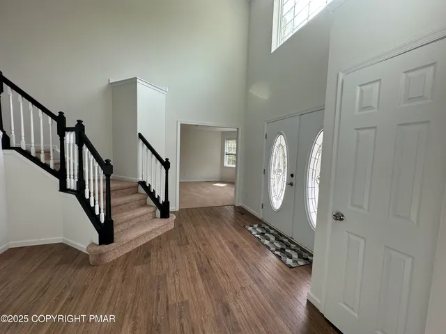 an empty room with windows and entrance