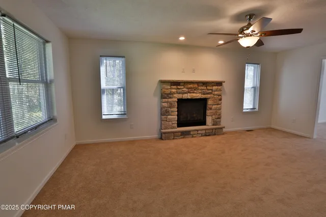 a kitchen with stainless steel appliances kitchen island granite countertop a refrigerator and a sink