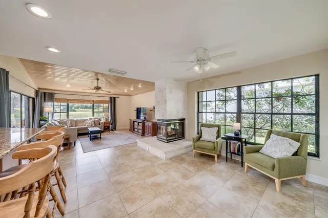 a living room with furniture and large windows