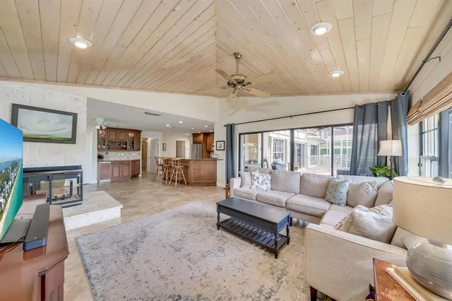 a bedroom with furniture and a large window