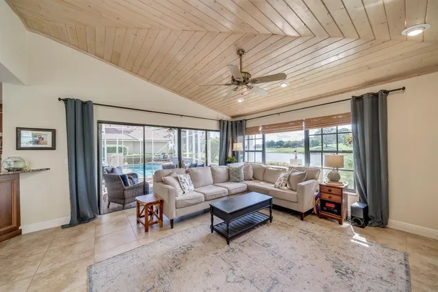a spacious bedroom with a bed a couch and a chandelier