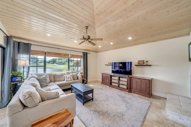a large bathroom with a tub sink and mirror
